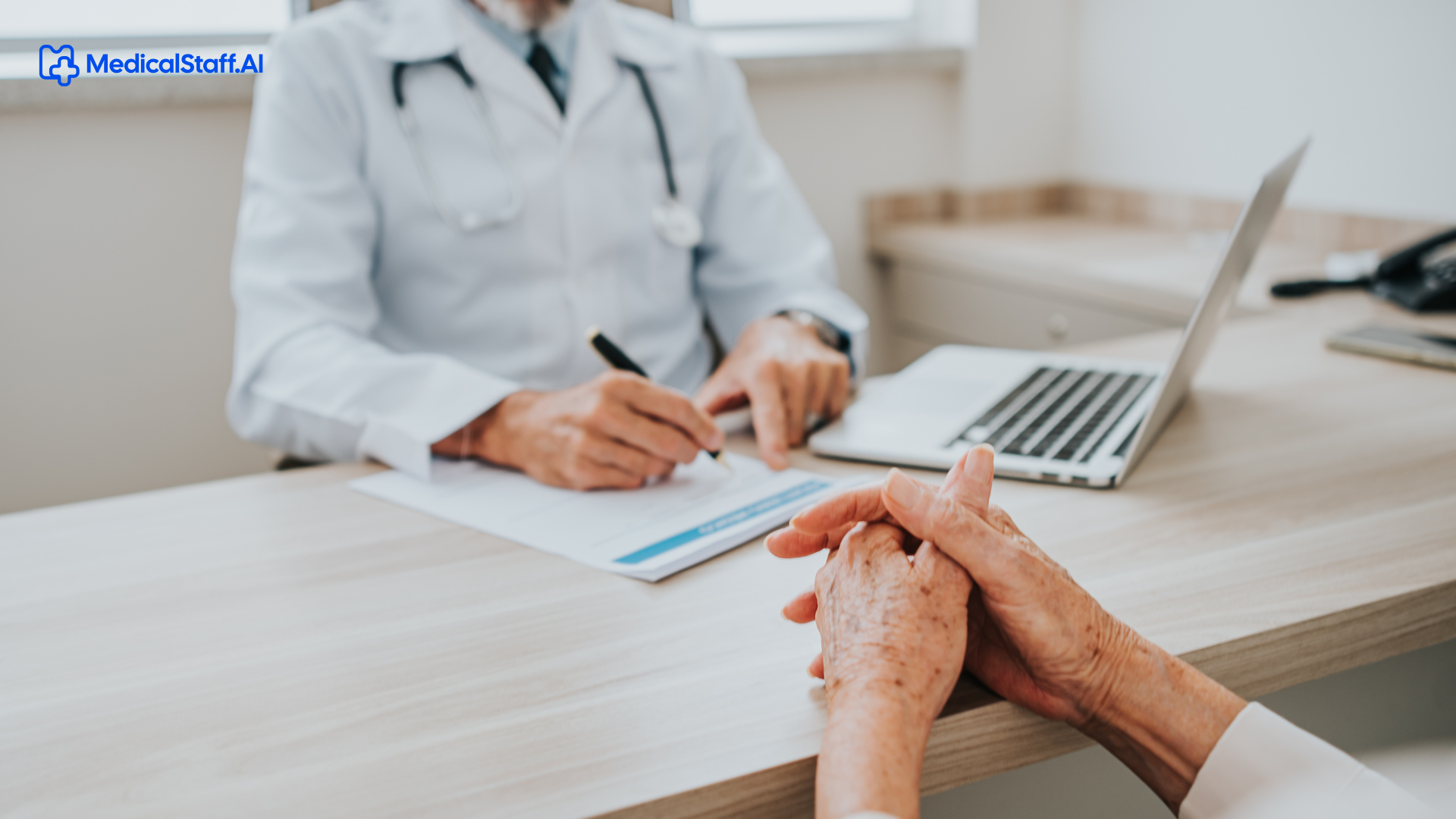 Healthcare professional working at a desk while using a laptop